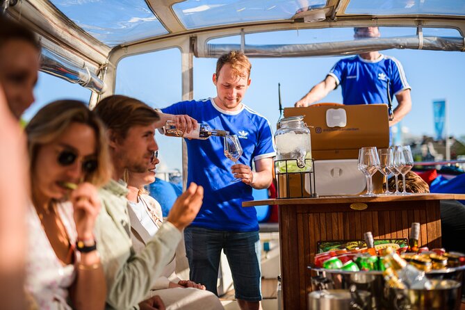 Amsterdam: Canal Booze Cruise with Unlimited Drinks Option - Weather, seating, and boarding details