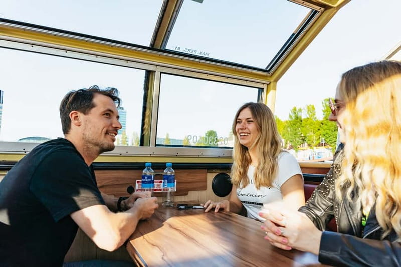 Amsterdam: City Centre Canal Cruise & Free Flower Cocktail - Audio guides, captains, and language choices