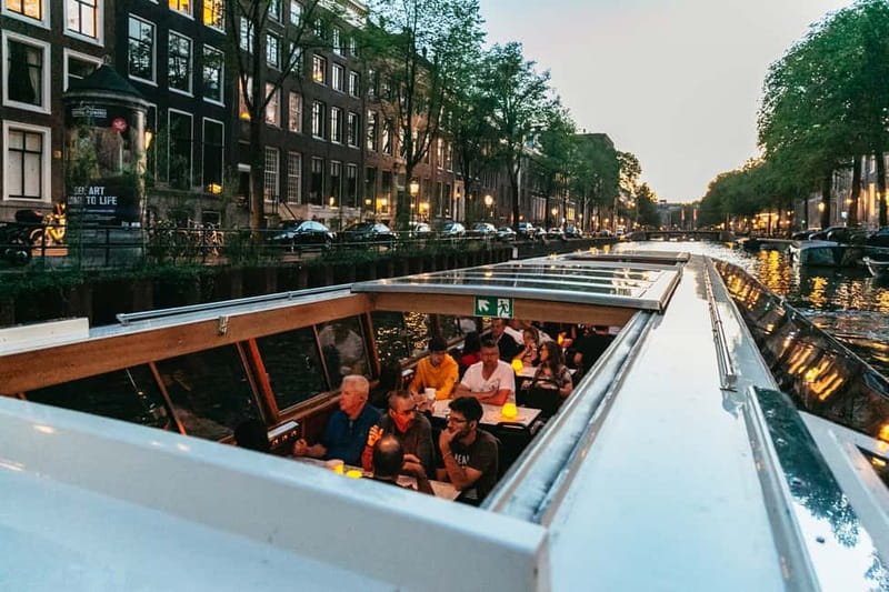 Amsterdam: Evening Cruise with Optional Wine and Snacks - Indoor comfort, outdoor views, and rainy weather