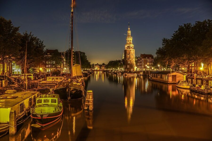 Amsterdam: Private Romantic Evening Boat Tour with Prosecco - Amsterdam after sunset, seen from the water