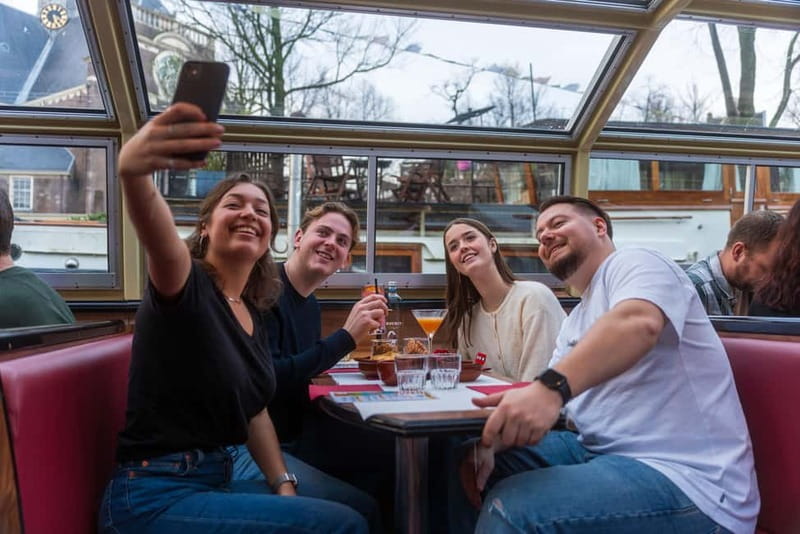 Amsterdam: Unlimited Cocktails Cruise on the Canals - Damrak, Centraal Station, and the first city views