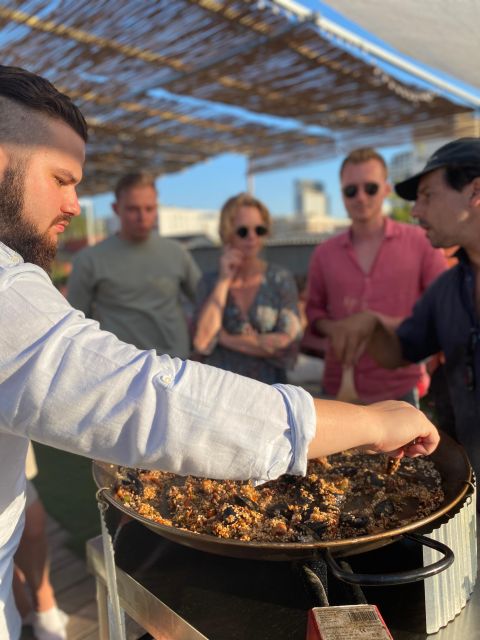 Barcelona: Rooftop Paella Cooking Class with Sangria - Sitting down to eat what you made
