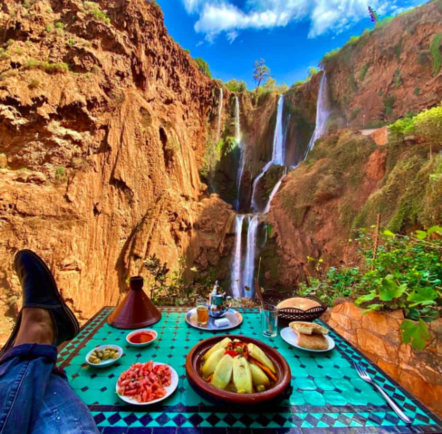 From Marrakech:Ouzoud Waterfalls Day Trip with Boat Tour - First views: red cliffs, trees, and open valley