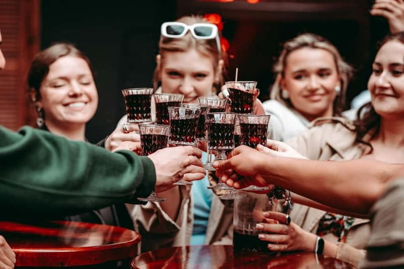 Krakow: Tipsy Polish Food Tour With History, Pierogi & Shots - The first tastes: pretzel, cherry liqueur, and local customs