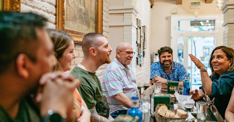 Madrid: Food & Wine Tour with 10 Tapas & 4 Drinks Included - Stop one: market cuisine and a quick start