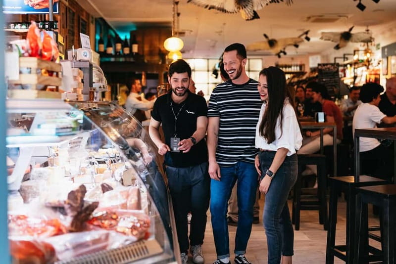Madrid: Guided Tapas and Wine Tour with Rooftop Views - Iberian ham and sausage near Plaza Mayor