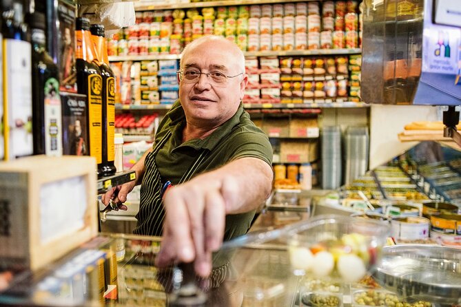 Madrid Ultimate Spanish Cuisine Food Tour - Cheese, wine, and a deli with a political past