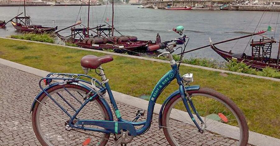 Porto: Self-Guided Bike and Boat Tour with Port Wine Tasting - Crossing Dom Luís I Bridge into Gaia