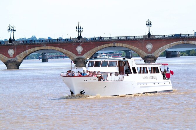Prestige Commented Cruise glass of wine and Canelé in Bordeaux - Bordeaux from the Garonne, with a canelé in hand